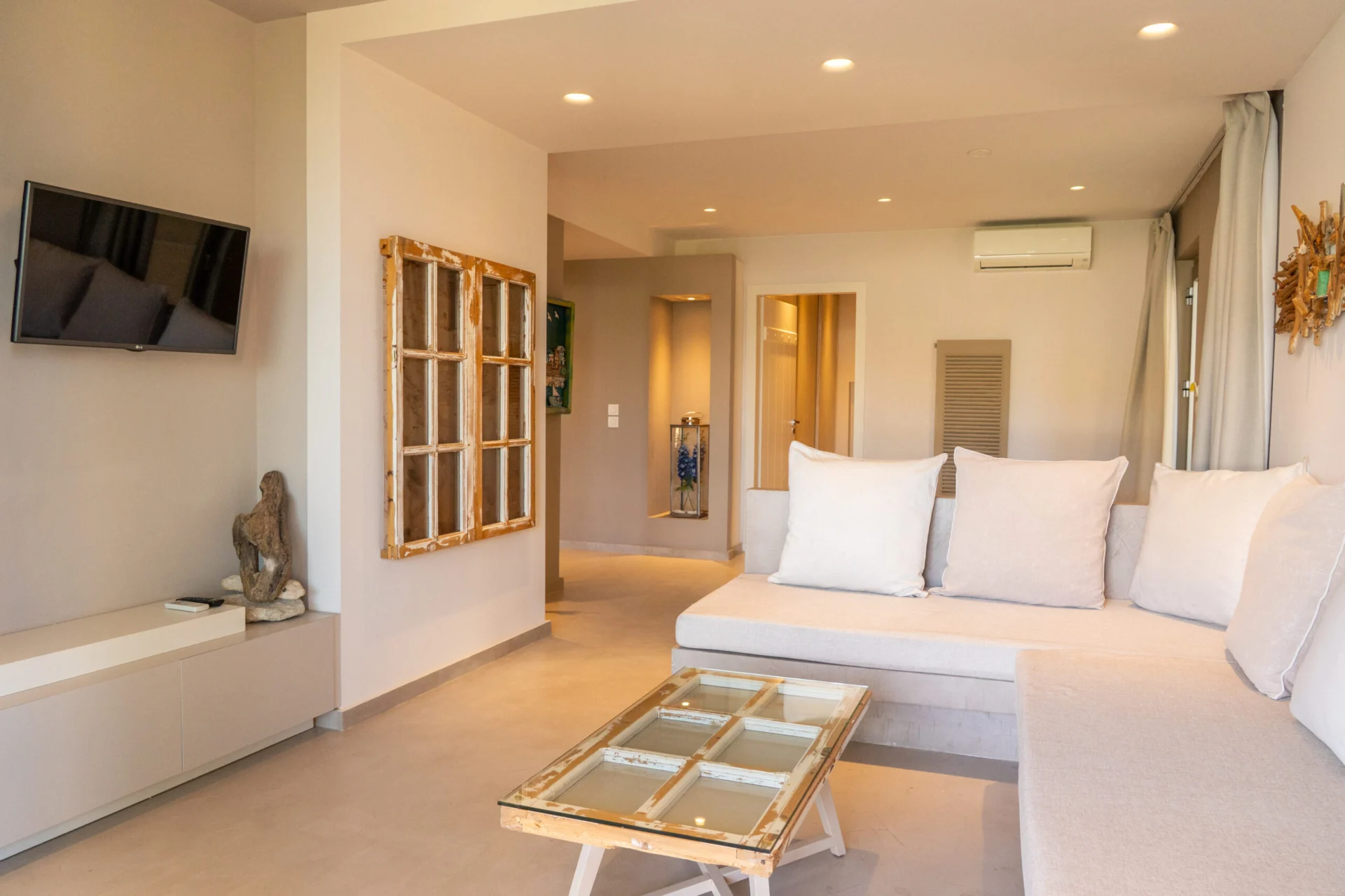The open-plan room with the bed at one end and the sofa at the other in the Kassandra Signature Suite at CORE Luxury Suites, Skiathos.