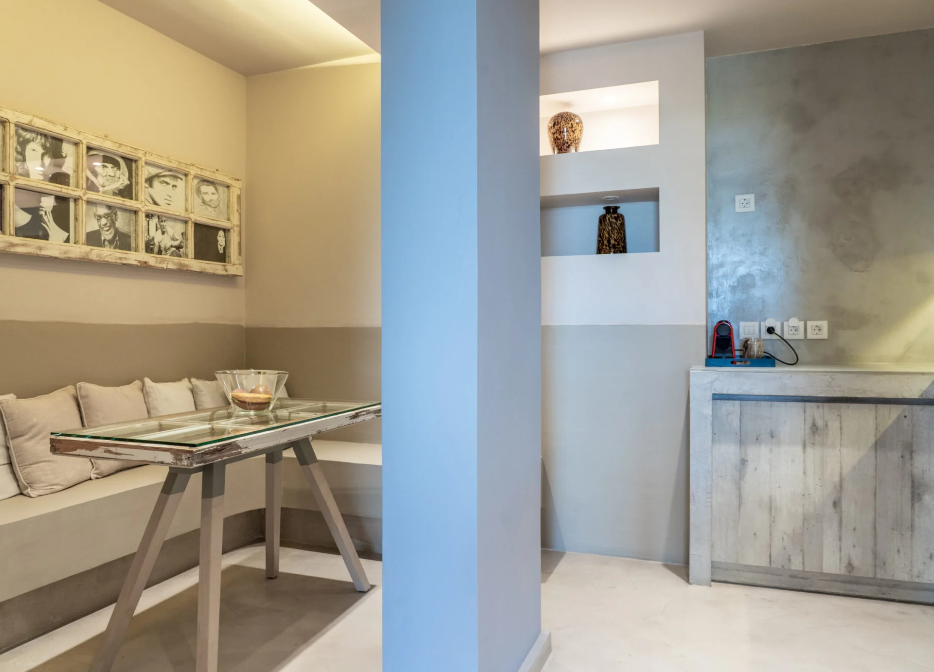 A glass dining table with built-in bench seating in the Maggi Superior Suite at CORE Luxury Suites, Skiathos.