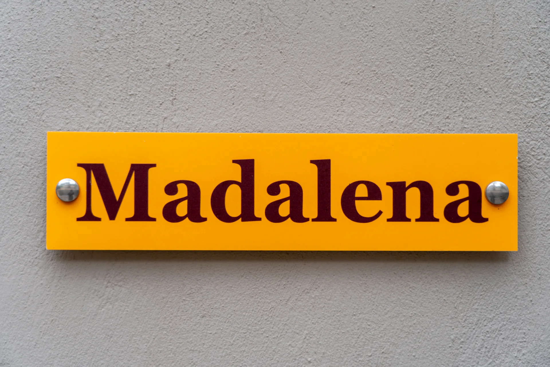 The suite's amber name plaque beside its door in the Madalena Superior Suite at CORE Luxury Suites, Skiathos.