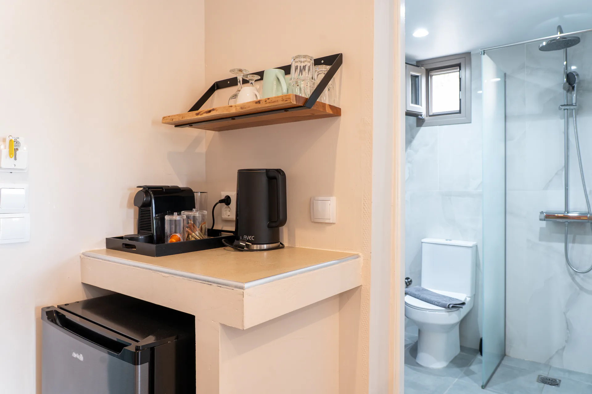 A kitchenette counter with the glass shower room beyond in the Madalena Superior Suite at CORE Luxury Suites, Skiathos.