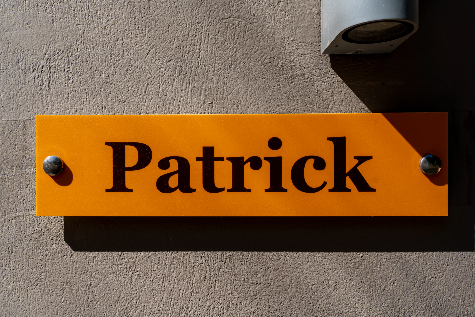 The suite's amber name plaque beside its door in the Patrick Family Suite at CORE Luxury Suites, Skiathos.
