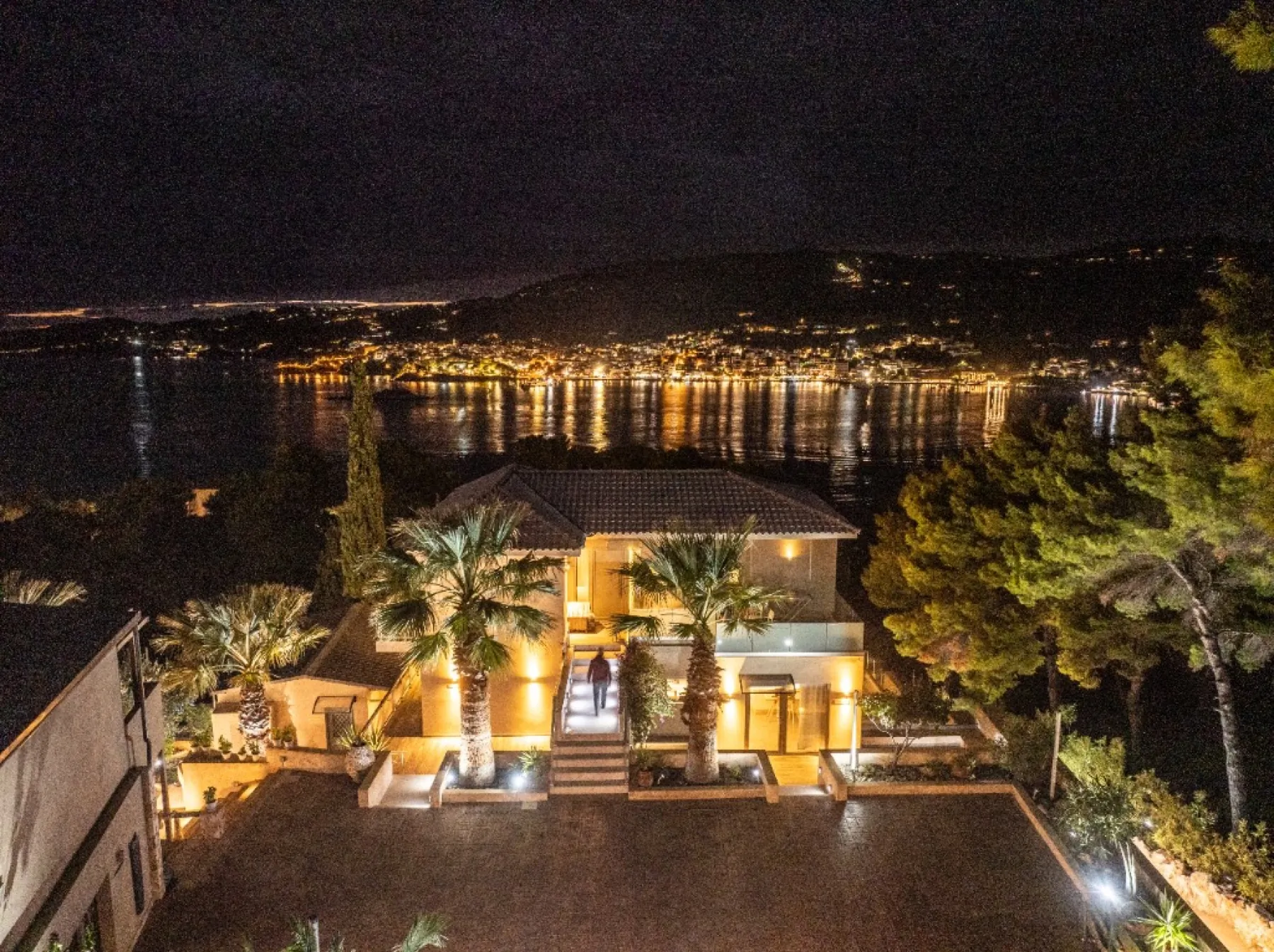 The entrance courtyard and palms at CORE Luxury Suites after dark