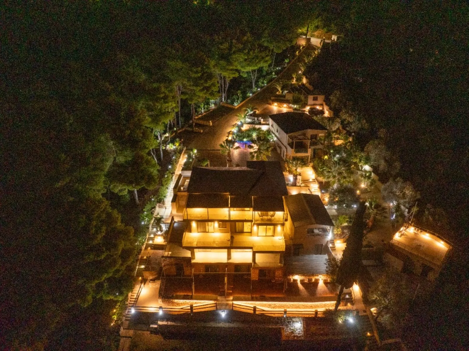 CORE Luxury Suites terraces glowing at night among the pines