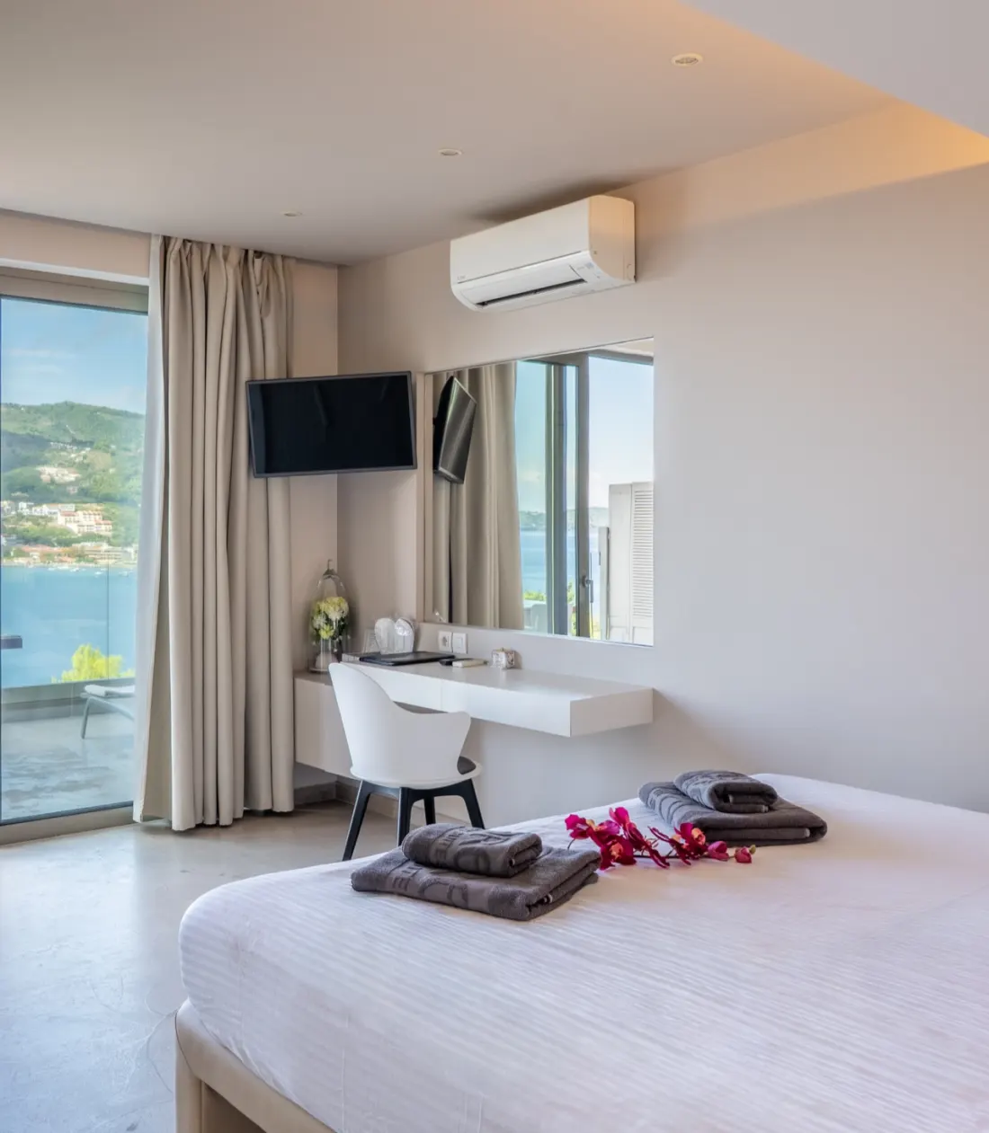 A suite opening onto its terrace, with Skiathos Town across the water
