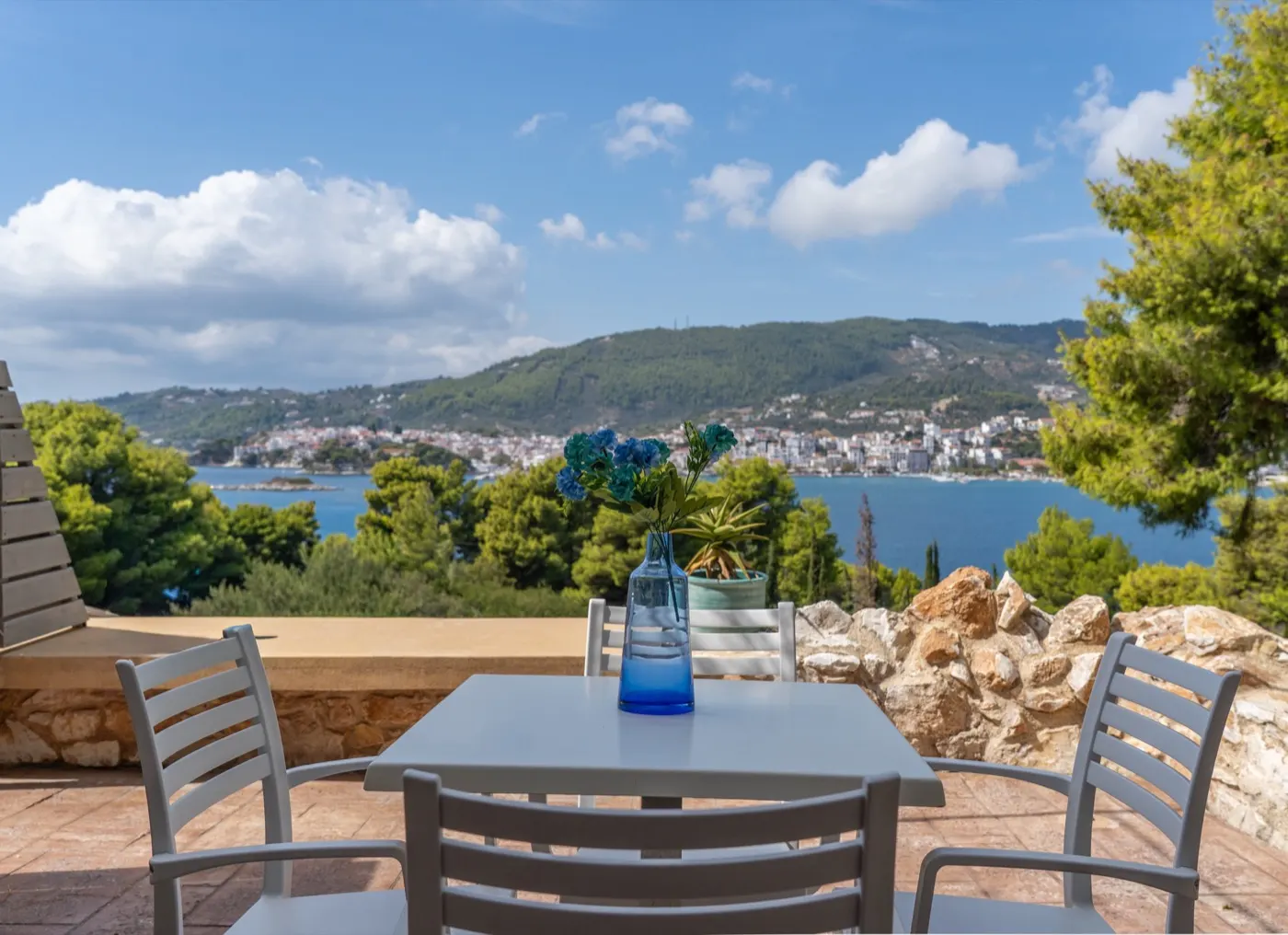 A terrace table looking across the bay to Skiathos Town, CORE Luxury Suites