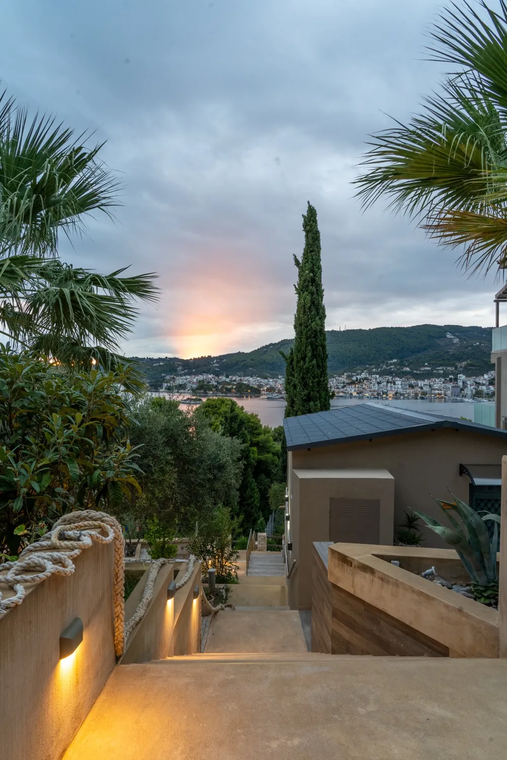 Skiathos Town across the water at sunset, seen from the garden steps at Core Luxury Suites