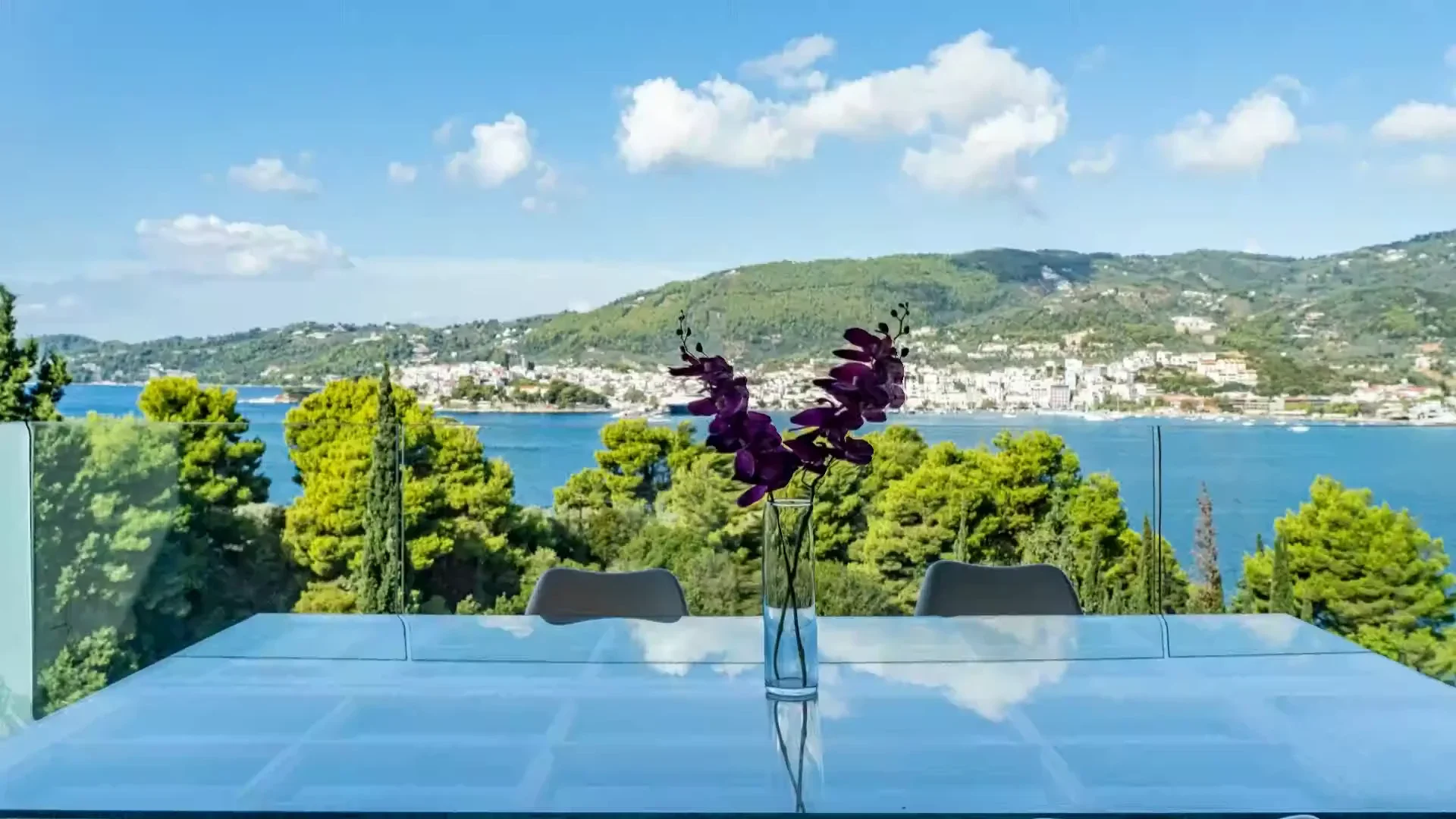 The bay and Skiathos Town seen through the pines from a terrace at Core Luxury Suites
